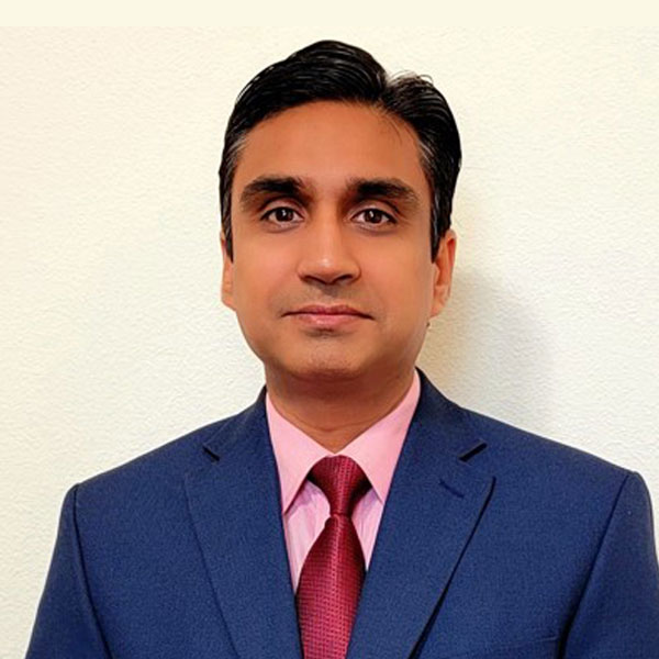 Students working at desk together drinking coffee
