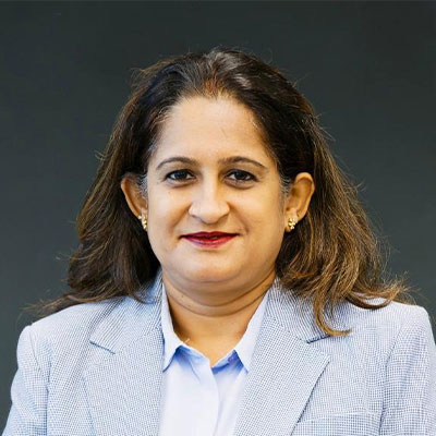 Students working at desk together drinking coffee